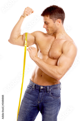 Muscular and tanned man is being measured