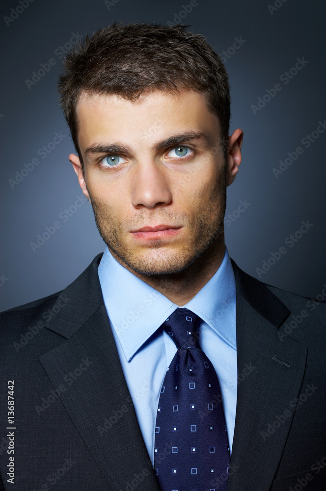 Portrait of business man isolated on dark background Portrait of business man isolated on dark background