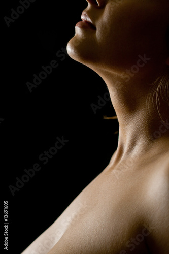 Body of young woman on black background © JanJar