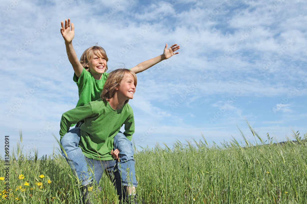 happy children playing outdoors winning piggyback race happy children playing outdoors winning piggyback race