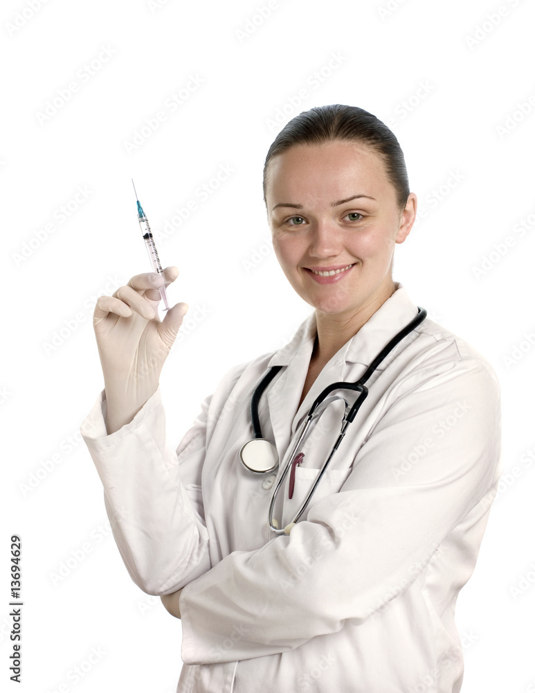 A pretty young doctor holding syringe on white background A pretty young doctor holding syringe on white background