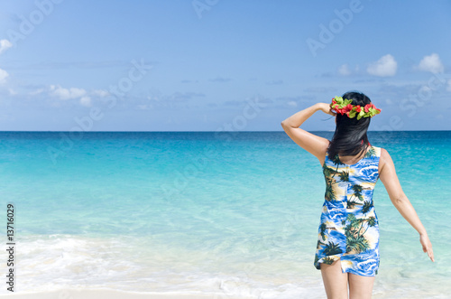 Woman in Tropical Dress Standing on a Beach