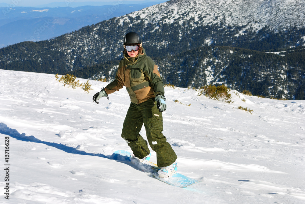 Snowboarder woman under sun