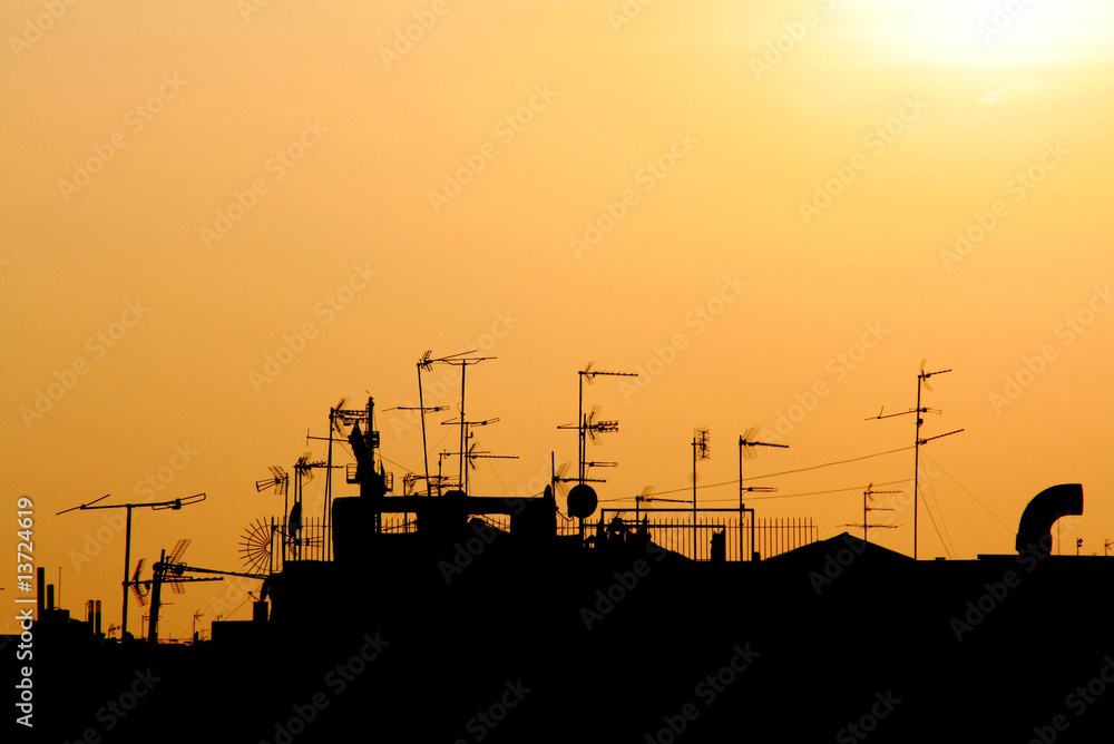 cutout of a sunset on a city roofs skyline