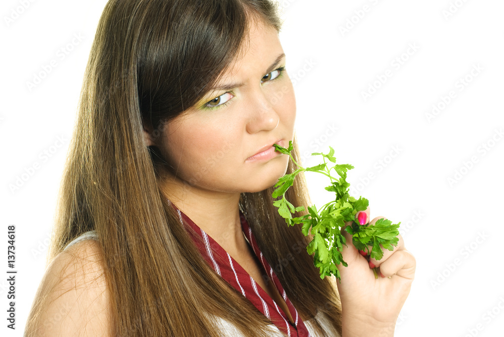 unhappy girl eating green parsley unhappy girl eating green parsley