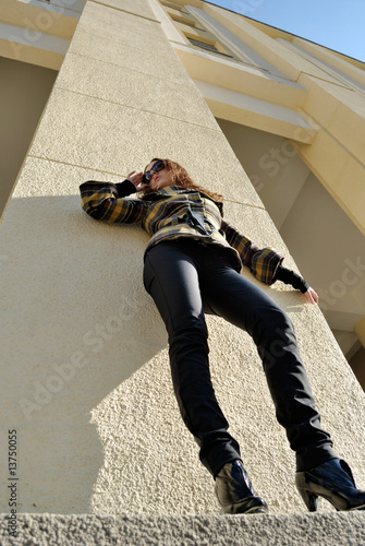 Standing woman in sun glasses, low angle view