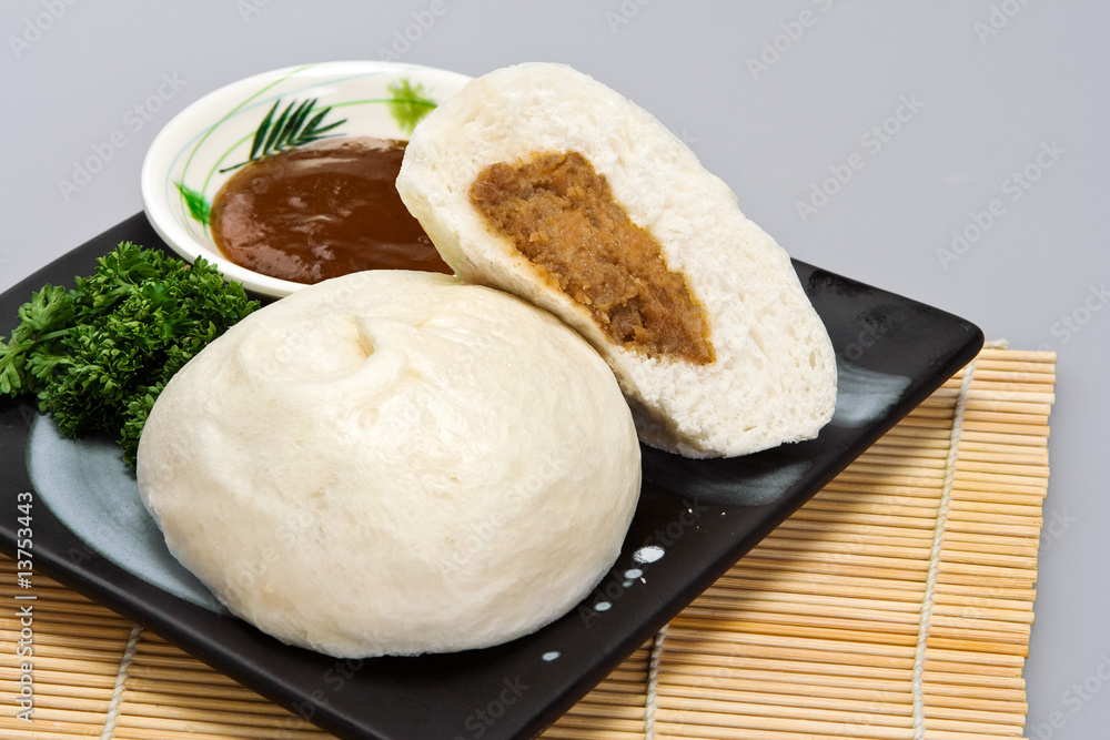 Meat-stuffed steamed bun with hoisin sauce Meat-stuffed steamed bun with hoisin sauce