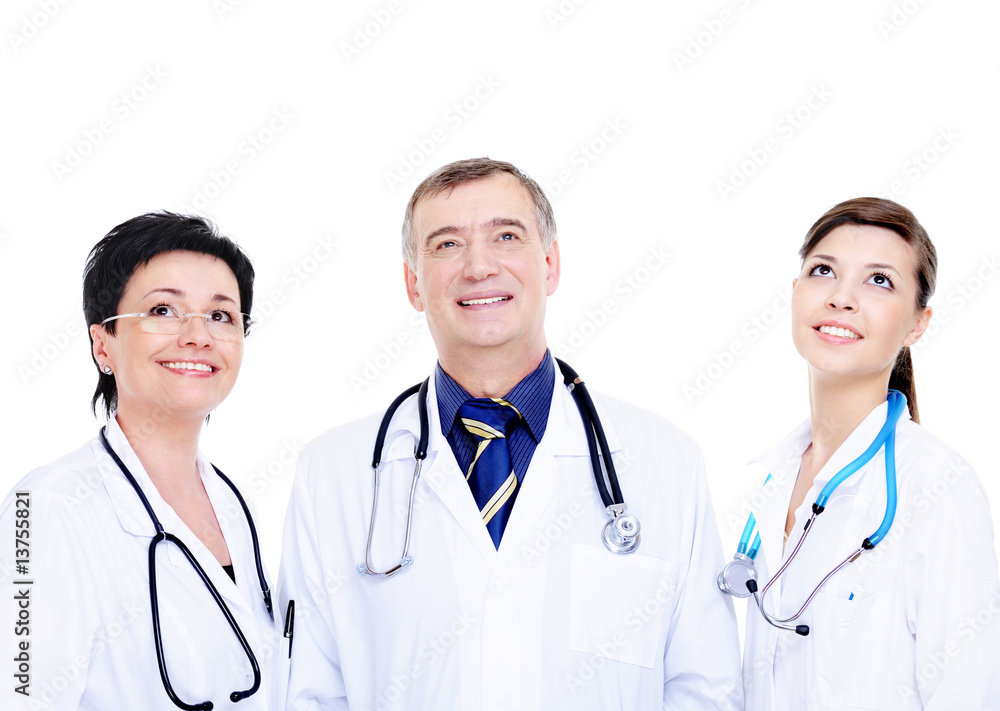 three laughing successful doctors looking up three laughing successful doctors looking up