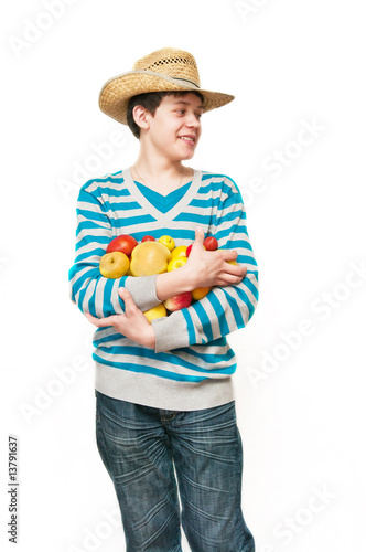 The young man in a straw hat with fruit