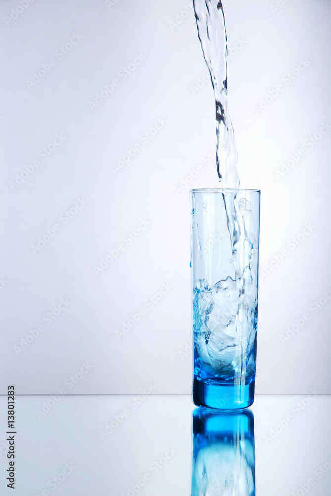 Liquid pouring into blue shot glass Liquid pouring into blue shot glass
