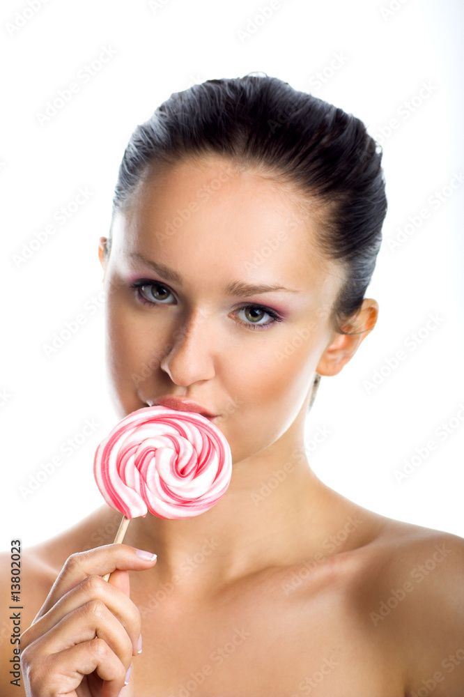 beauty portrait of a young woman with a lollipop