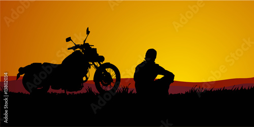 motociclista al tramonto photo