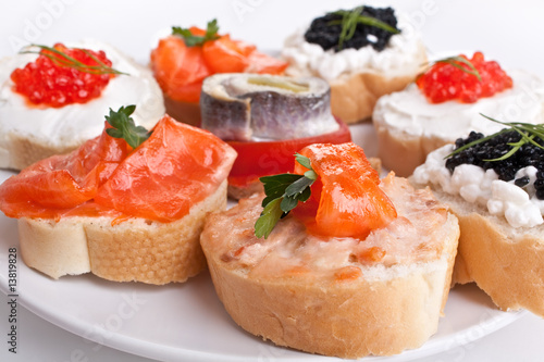 sandwiches with red and black caviar, herring and salmon