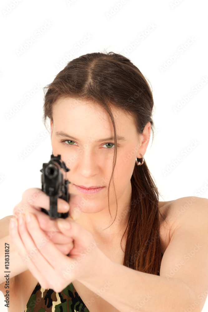 Portrait of young woman aiming gun, studio shot Portrait of young woman aiming gun, studio shot