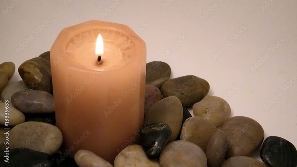 Candle and pebbles