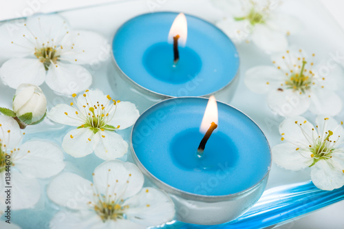 Candle with spring flowers in water