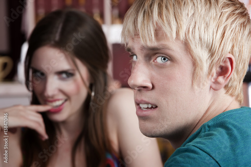 Woman flirting with uninterested male friend