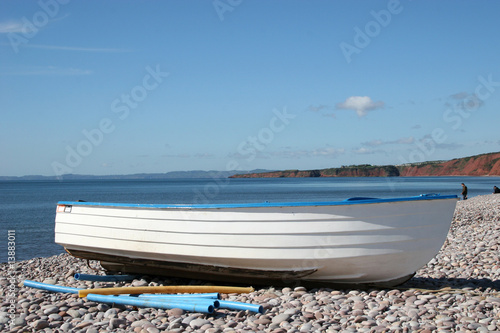 dinghy on shingle beach photo