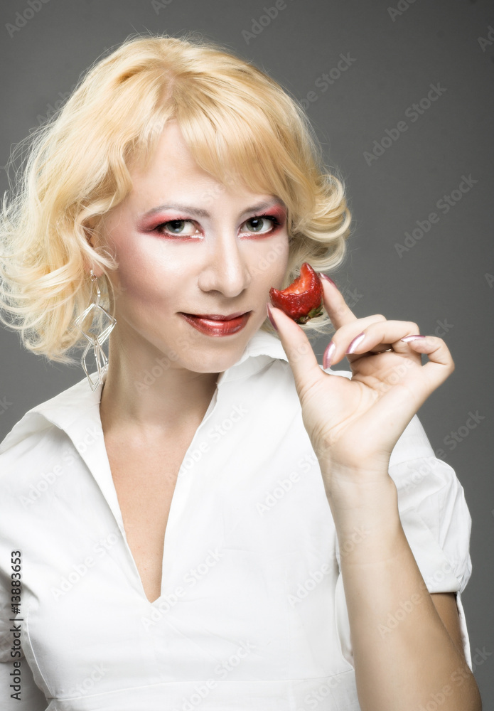 Portrait of young woman with strawberry Portrait of young woman with strawberry