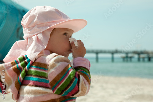 sneezing baby on the beach