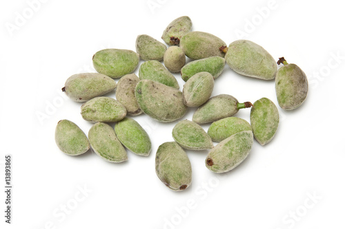 Fresh green almonds isolated on a white studio background.