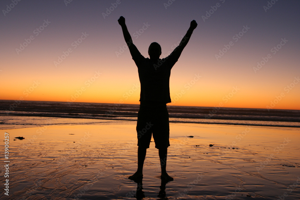 Man Raising Hands in Sunset