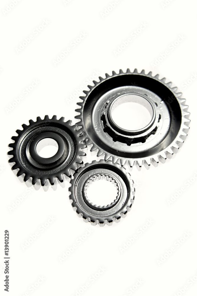 Three gears meshing together over white Three gears meshing together over white