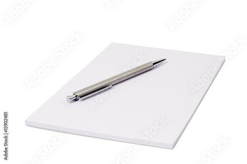 White notepad isolated over white with a ball pen