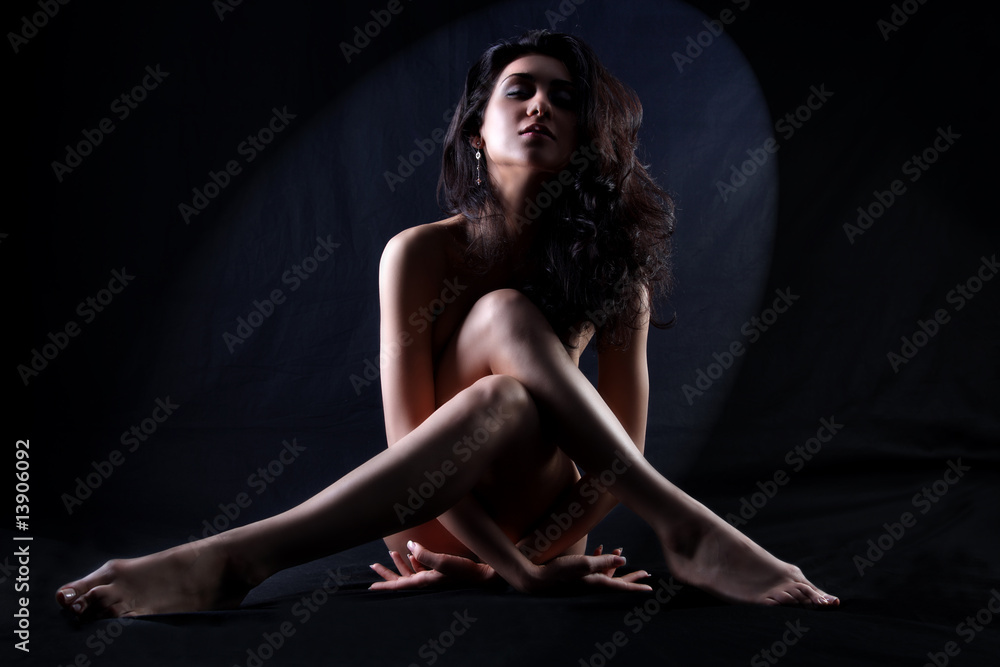 fine art portrait nude girl sitting against black background