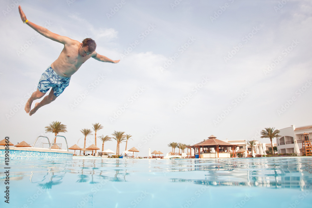 Man jumping in swimming pool