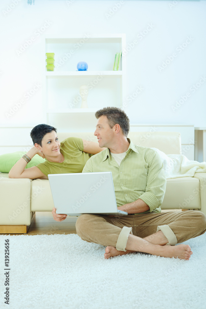 Couple using computer at home Couple using computer at home