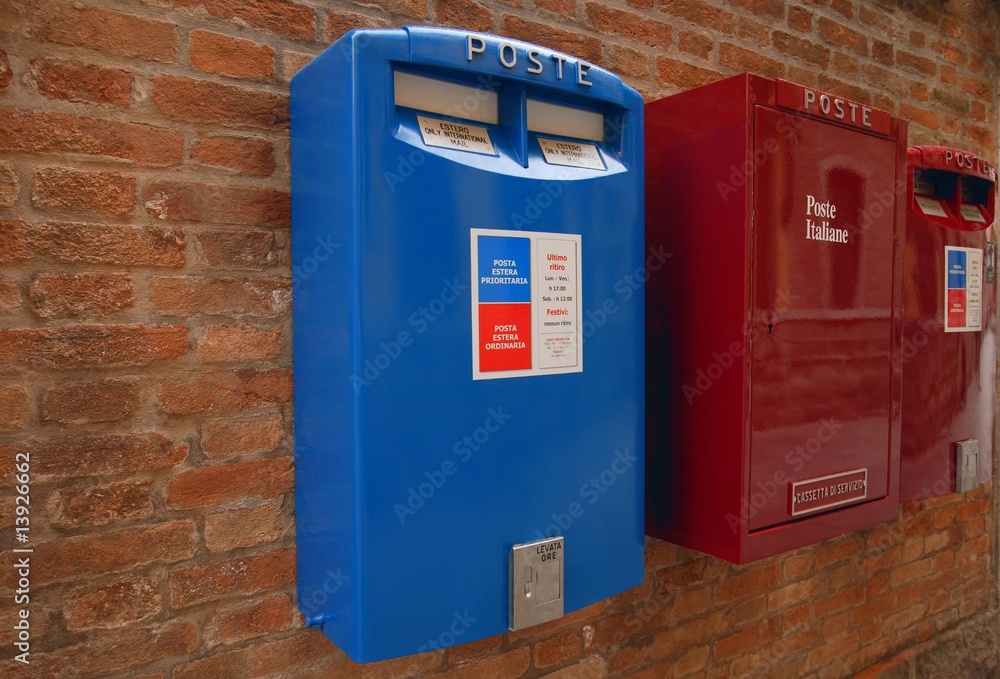 Italian mailboxes hanging on a brick wall in Italy Europe Italian mailboxes hanging on a brick wall in Italy Europe