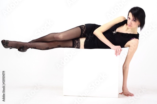 woman in short dress lies on a white background