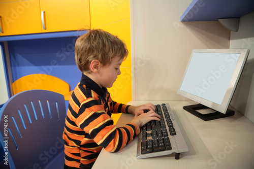 boy at computer in children's room photo