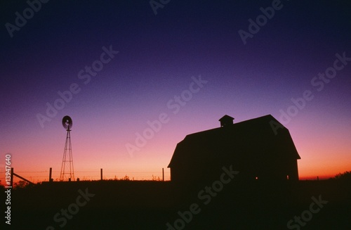 Silhouette of barn and windmill