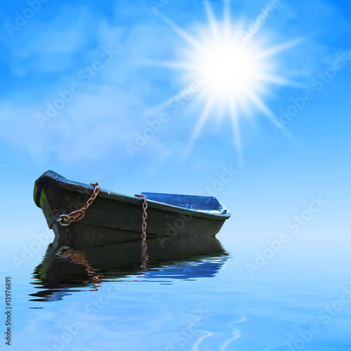 Abandoned rowboat under the sun