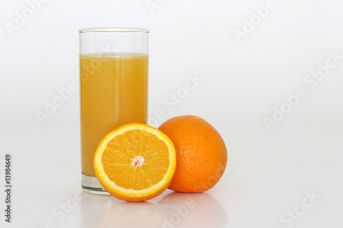 A glass of fresh orange juice on a white background