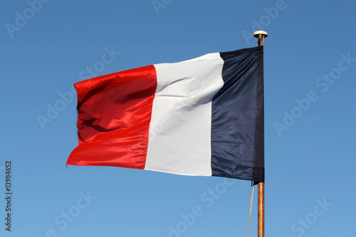 Foto The French tricolour flapping in the wind on a flagpole.
