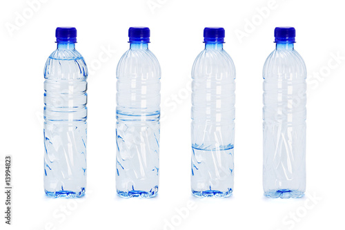 Картината върху платно Plastic bottles with different water levels inside