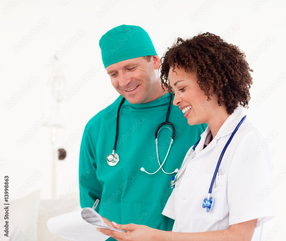 Happy Doctors reading a report in a ward Happy Doctors reading a report in a ward