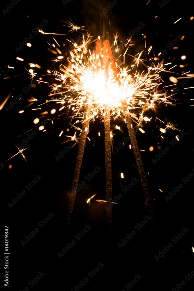 Obraz premium yellow sparkler with fire particles