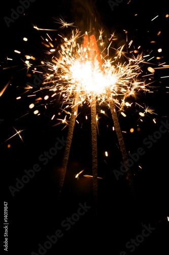 yellow sparkler with fire particles