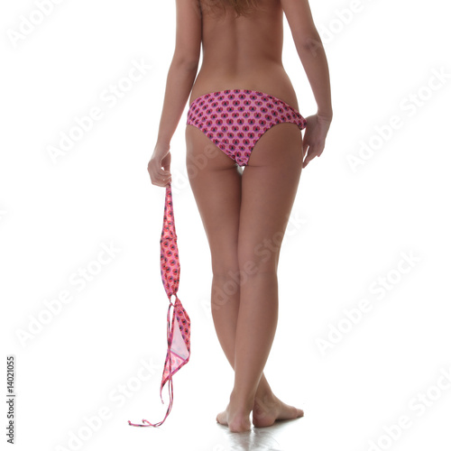 Young woman topless - with top of bikini in her hand