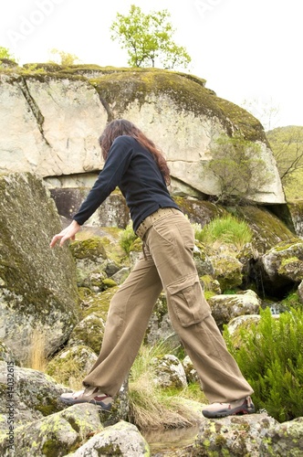 woman walks on the rocks