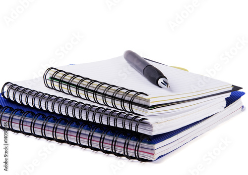 Three spiral notebooks and pen