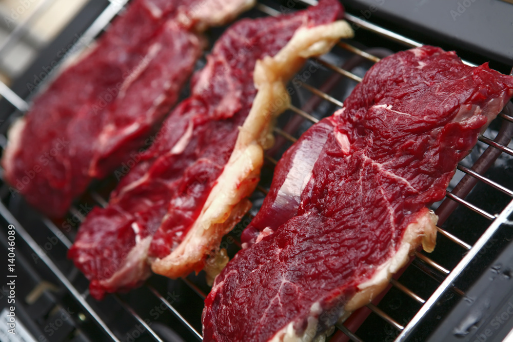 uncooked steak on roaster