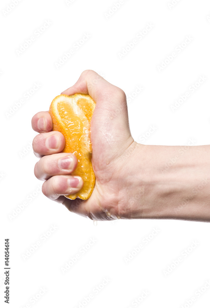 Hand squeezing an orange towards white background Hand squeezing an orange towards white background