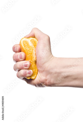Hand squeezing an orange towards white background