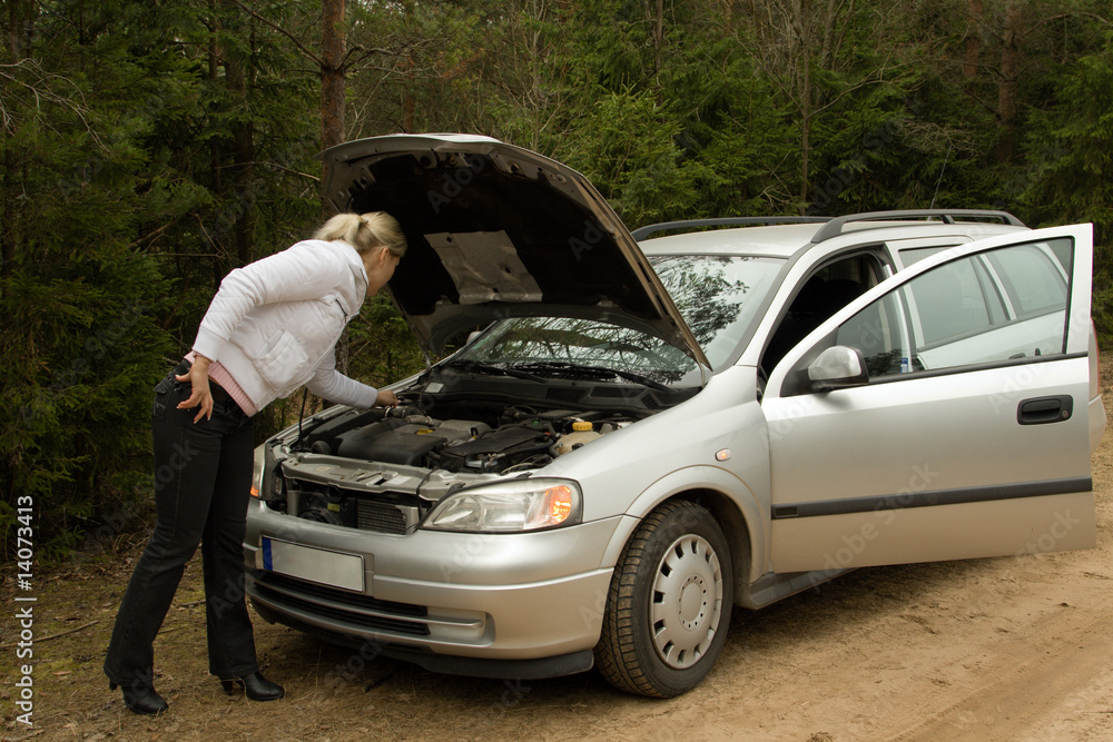 Girl with her broken silver car. Girl with her broken silver car.