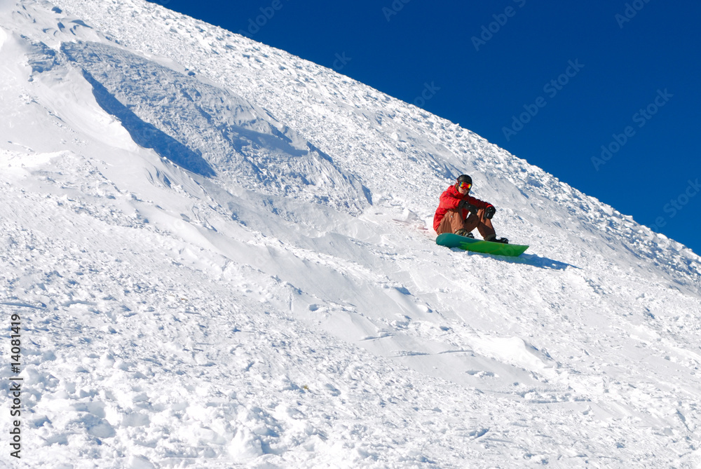 Snowboarder under sun